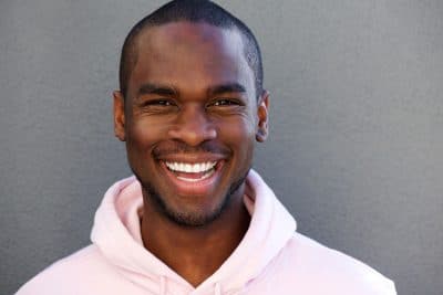 young adult man happily smiling with teeth