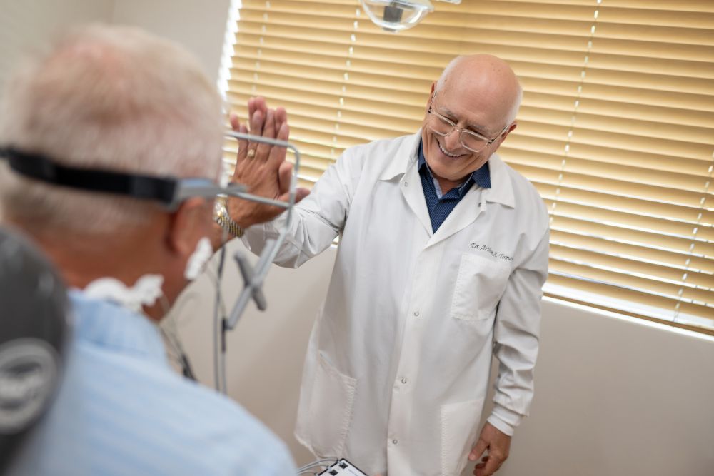Dr. Tomaro guides a patient through a computerized jaw evaluation at our Naples, FL dental office