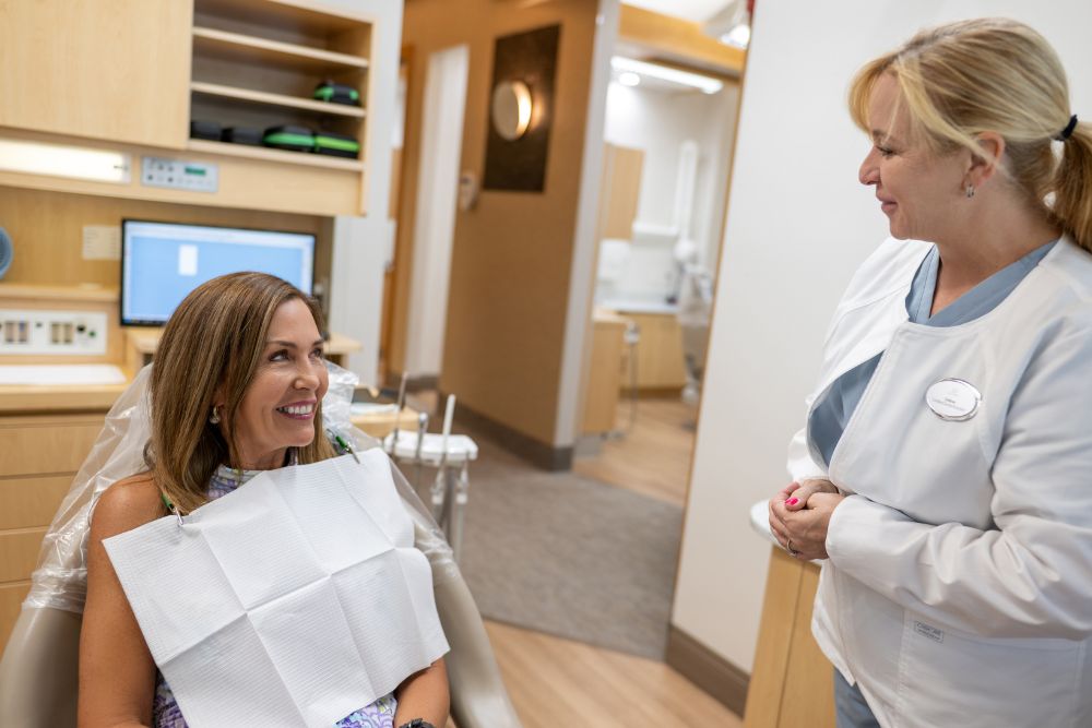 Our Naples, FL dental team checks on a patient during personalized porcelain veneer treatment