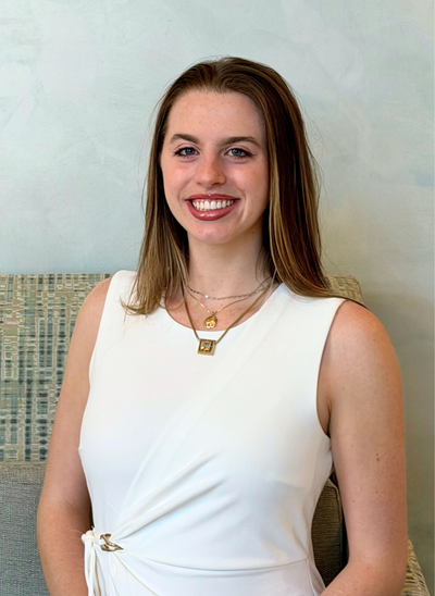 Camryn - Dental Assistant sitting in a chair smiling